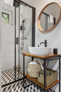 a bathroom with a sink and a mirror at VD Boutique Apartments No 2 in Bucharest