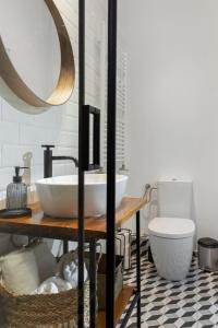 a bathroom with a sink and a toilet at VD Boutique Apartments No 2 in Bucharest