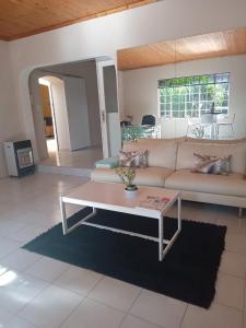 a living room with a couch and a coffee table at "O Sole Mio" Self catering studio apartment in Bedfordview in Bedfordview