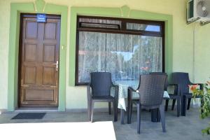 a table and chairs in front of a door at Apartment Kolonija in Slavonski Brod