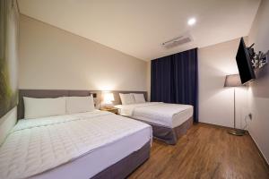 MTM Family Hotel客房内的一张或多张床位