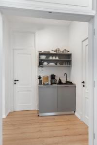 a kitchen with white walls and a counter top at VD Boutique Apartments No 1 Bucharest in Bucharest