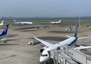 an airplane is parked on the runway at an airport at APA Hotel Haneda Anamori Inari Ekimae in Tokyo