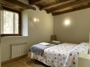 a bedroom with a bed and a window at Palacio de Aralar in Oskotz