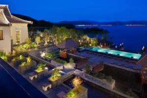 an aerial view of a house with a swimming pool at night at Park Hyatt Ningbo Resort & Spa in Ningbo