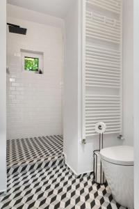 a bathroom with a black and white checkered floor at VD Boutique Apartments No 3 in Bucharest