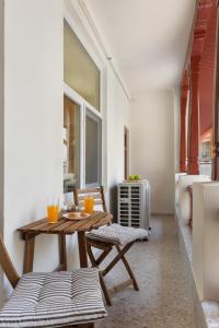 a table and chairs in a room with a window at VD Boutique Apartments No 3 in Bucharest