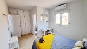 a bedroom with a dog sitting on a bed at La Casita del Arco Panorámico in San Pedro