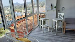 a living room with a table and chairs on a balcony at La Casita del Arco Panorámico in San Pedro