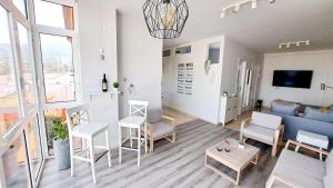 a living room with white furniture and a blue couch at La Casita del Arco Panorámico in San Pedro