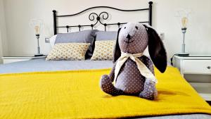 a stuffed rabbit sitting on a bed at La Casita del Arco Panorámico in San Pedro