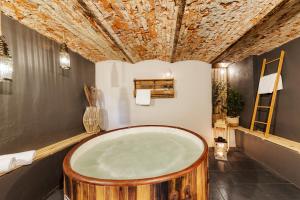 a wooden bath tub in a room with a stone ceiling at Prywatna Wieś in Mörken