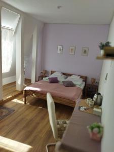 a bedroom with a bed and a table in it at Митяевский Mityaevskyi Guest House in Kolomna