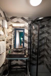 a bathroom with a sink and a mirror at Boutique Hotel Bura 45N in Senj