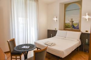 Postel nebo postele na pokoji v ubytování Hotel Regina Margherita