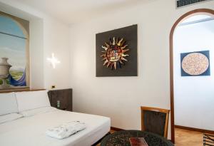 Postel nebo postele na pokoji v ubytování Hotel Regina Margherita