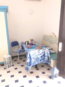 a room with a table and two chairs in it at Dammuso Cinzia, incantevole fronte mare in Pantelleria