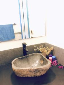 a stone sink in a bathroom with a window at Dammuso Cinzia, incantevole fronte mare in Pantelleria