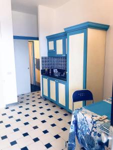 a room with a blue cabinet and a checkered floor at Dammuso Cinzia, incantevole fronte mare in Pantelleria