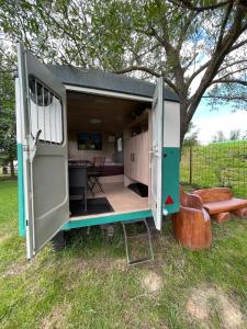 a tiny house with a door open in a yard at Residence Safari Resort - Teepee Village in Borovany