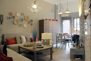 a living room with a couch and a table at Cozy house with relaxing backyard in Ermoupoli