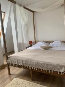 a bedroom with a large bed with a canopy at Митяевский Mityaevskyi Guest House in Kolomna