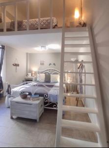 a bedroom with a bunk bed and a ladder at Cozy house with relaxing backyard in Ermoupoli