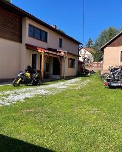 two motorcycles parked in front of a house at Holiday Home Křesánov in Vimperk
