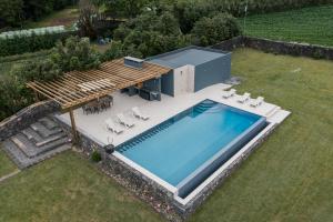 an overhead view of a swimming pool in a yard at Herdade do Lameiro - Turismo Rural in Ribeira Grande