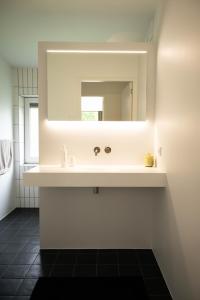 a bathroom with a sink and a mirror at It Merkelân in Beetsterzwaag