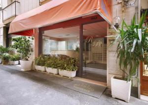 a store front with potted plants in front of it at Residence Barusso in Alassio