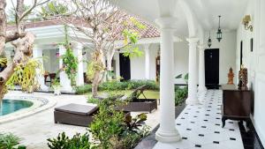 a courtyard of a house with a pool at Omatha Village in Denpasar
