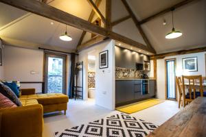 a kitchen and living room with a couch and a table at 17th Century Cartshed Nestled In Welsh Countryside in Pandy
