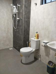 a bathroom with a toilet and a sink at AMNI Homestay Vista Bangi Muslim Preferred (Pool View) in Kajang