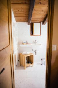 a bathroom with a sink and a table in it at Agriturismo La Burlanda in Fosdinovo