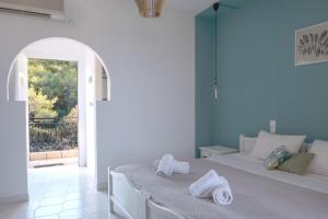 Voodi või voodid majutusasutuse Pefkides Aegina Boutique Apartments toas