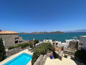 a villa with a swimming pool and a view of the water at Villa Helios in Elounda