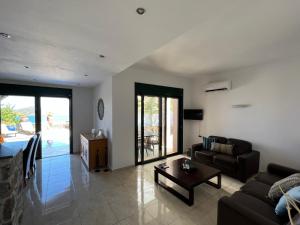 a living room with a couch and a table at Villa Helios in Elounda