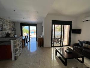 a living room with a couch and a table at Villa Helios in Elounda