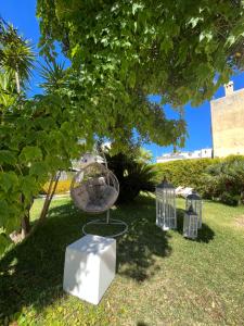 a group of bird cages sitting under a tree at Relais Corte Degli Aragonesi in Ischia