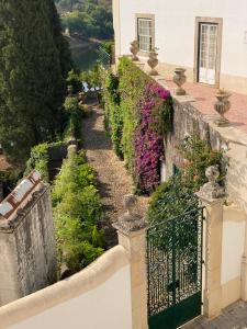 a balcony of a house with flowers on it at Constância Guest House in Constância