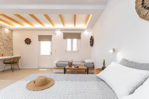 a bedroom with a bed with a hat on it at Naxos Finest in Naxos Chora