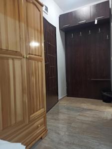 a room with wooden cabinets and a large closet at Family Hotel Silitur in Ahtopol