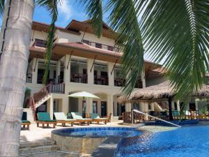 a resort with a swimming pool and a building at Sara Beachfront Boutique Resort in Pathiu