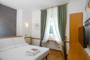 Postel nebo postele na pokoji v ubytování Hotel Regina Margherita