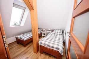 Posteľ alebo postele v izbe v ubytovaní Apartament Pastorówka