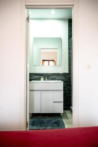 a bathroom with a white sink and a mirror at Casa Po in Granada