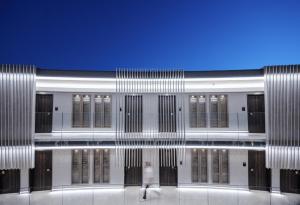 a building with a bunch of doors and windows at Nautilux Rethymno by Mage Hotels in Rethymno Town +133 photos