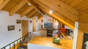 a kitchen with wooden ceilings and a wooden table at Appartement Lena in Weissach Im Tal