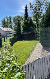 a fence next to a yard with a house at Appartement Micha in Weissach Im Tal